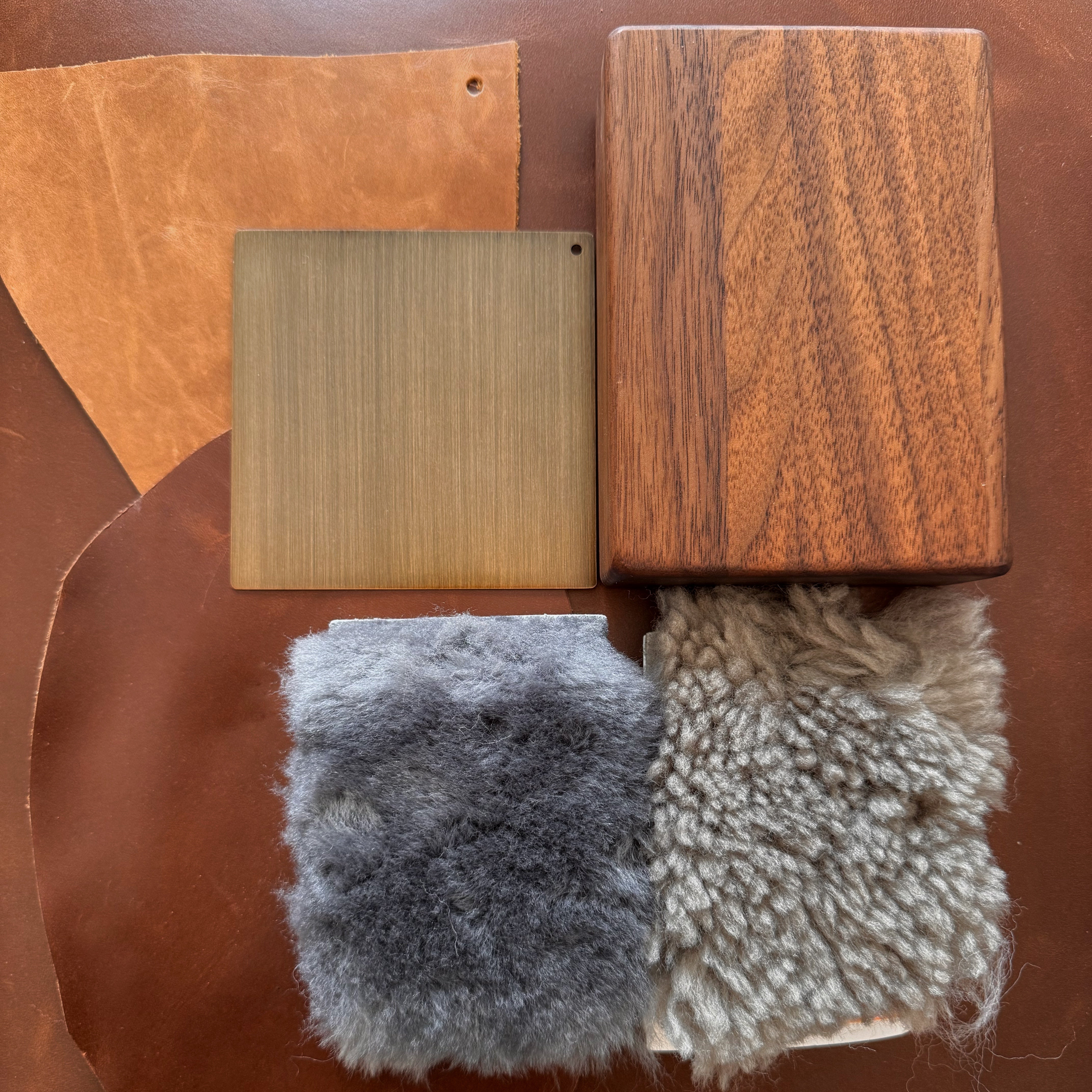 Wooden, leather, and fabric swatches on a brown background