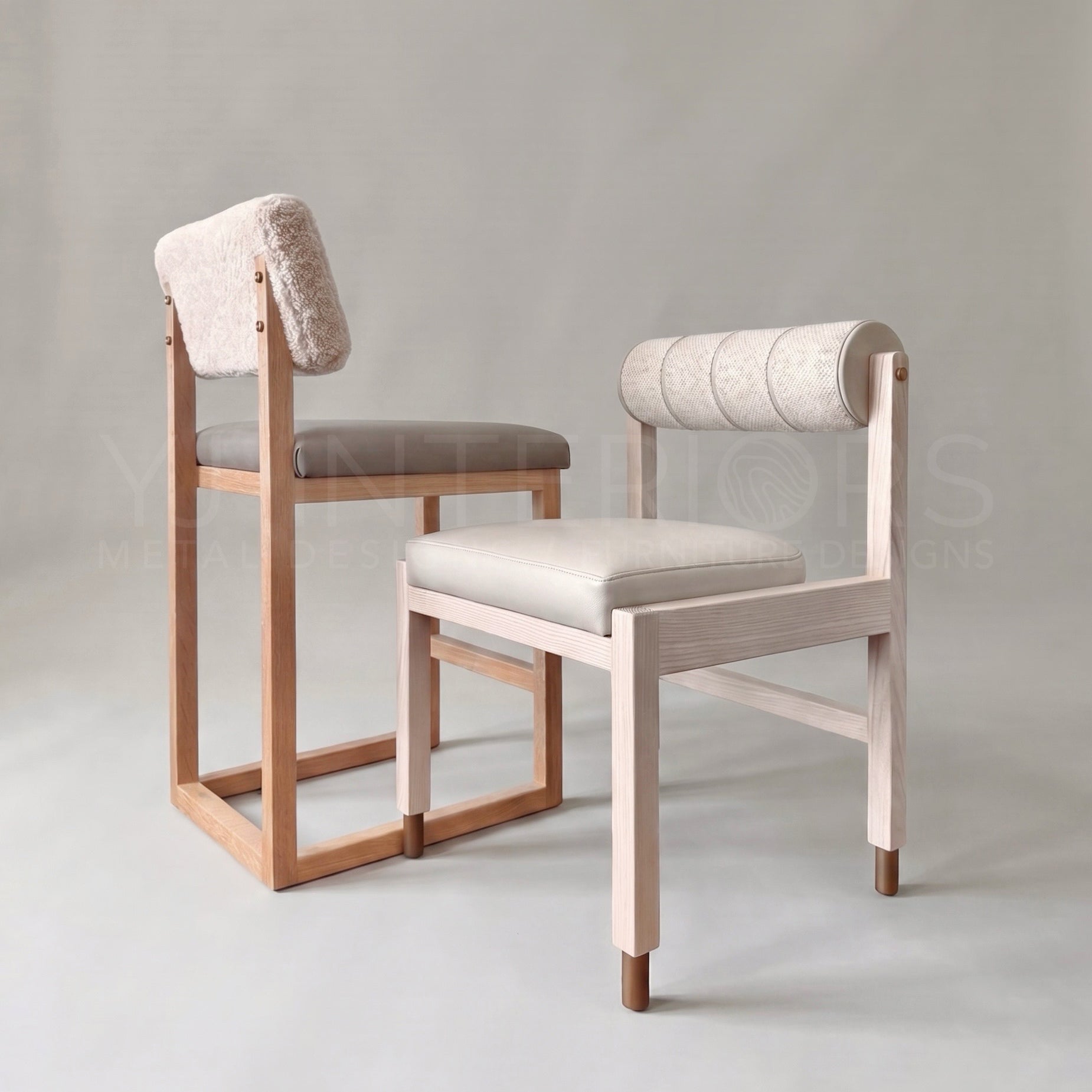 Two modern wooden dining chairs with upholstered seats and backs, shown on a neutral light gray studio background. One chair has a light natural wood frame, a beige upholstered seat, and a textured light pinkish-beige backrest.
