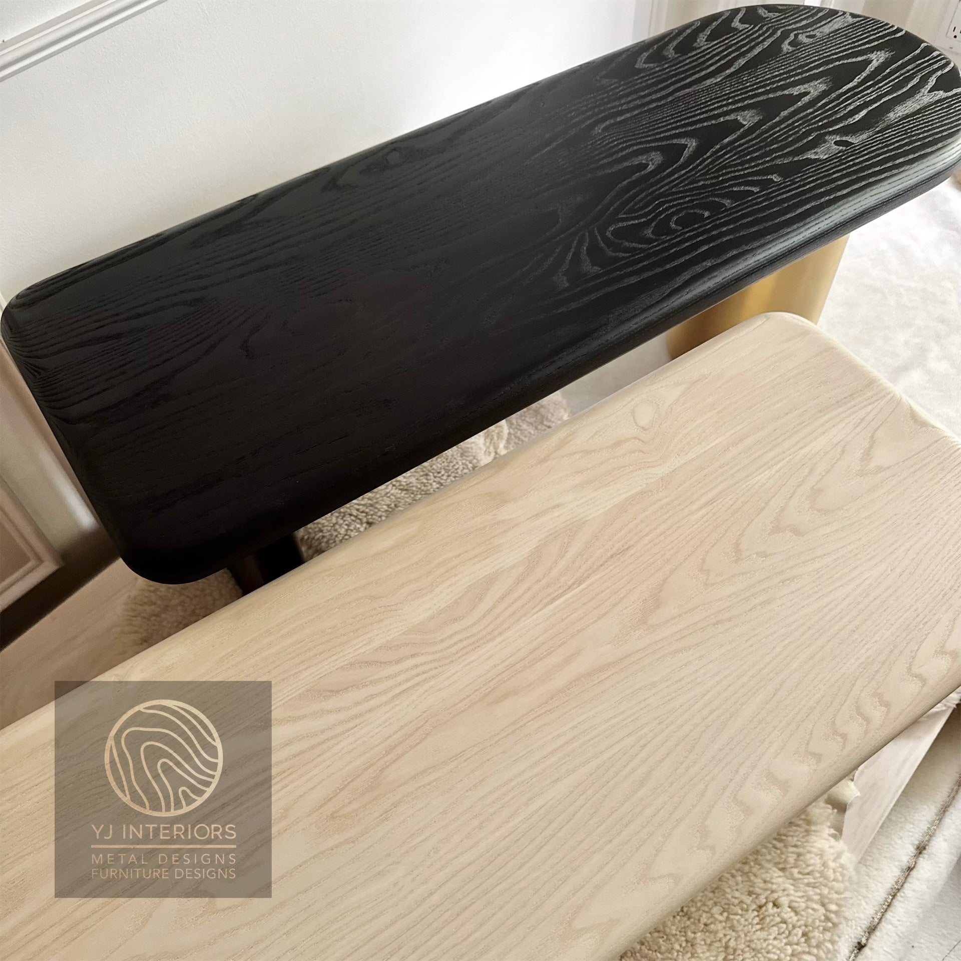 Wooden stool with a black cushioned seat and backrest, branded 'YJ Interiors'.