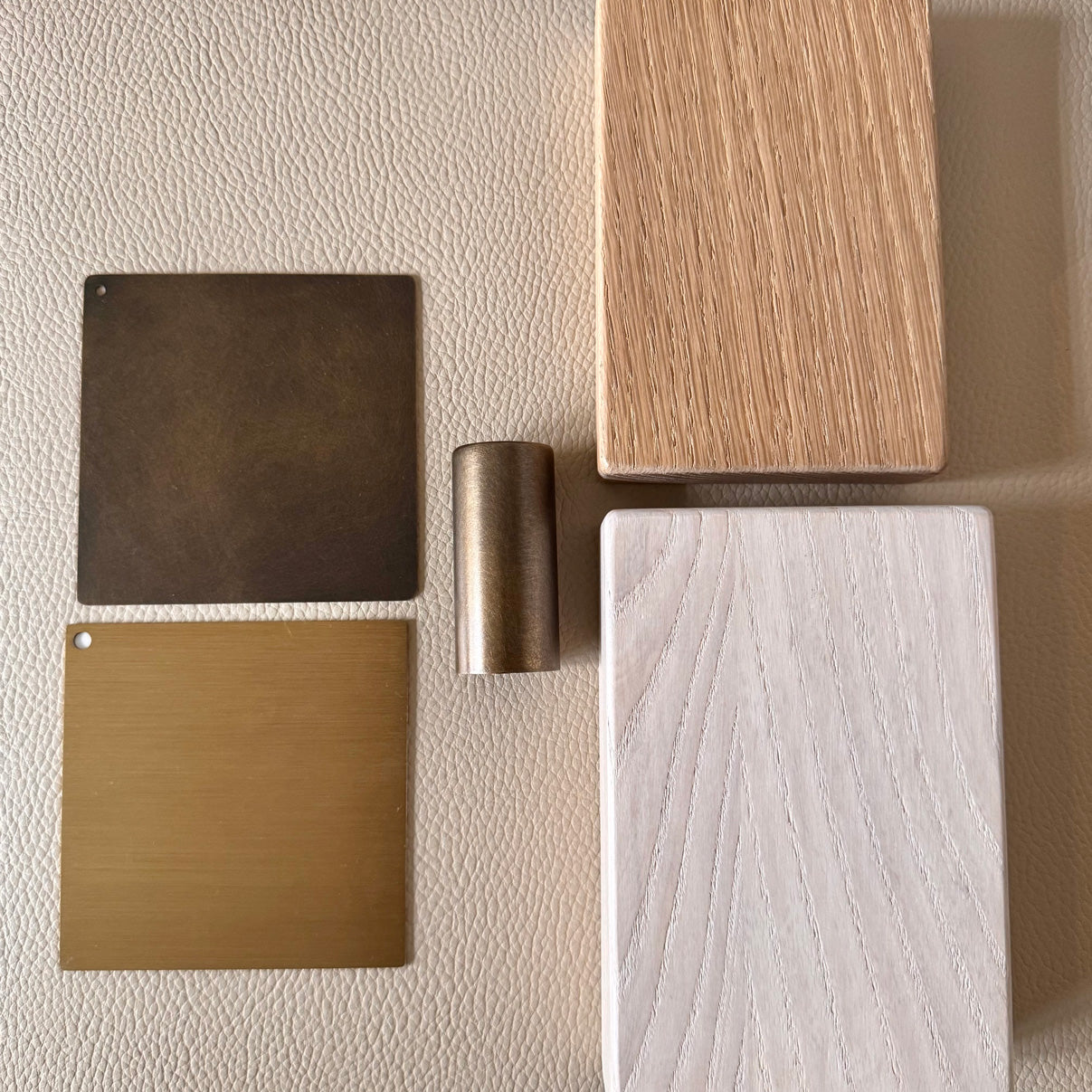 Four different wood samples on a textured beige surface
