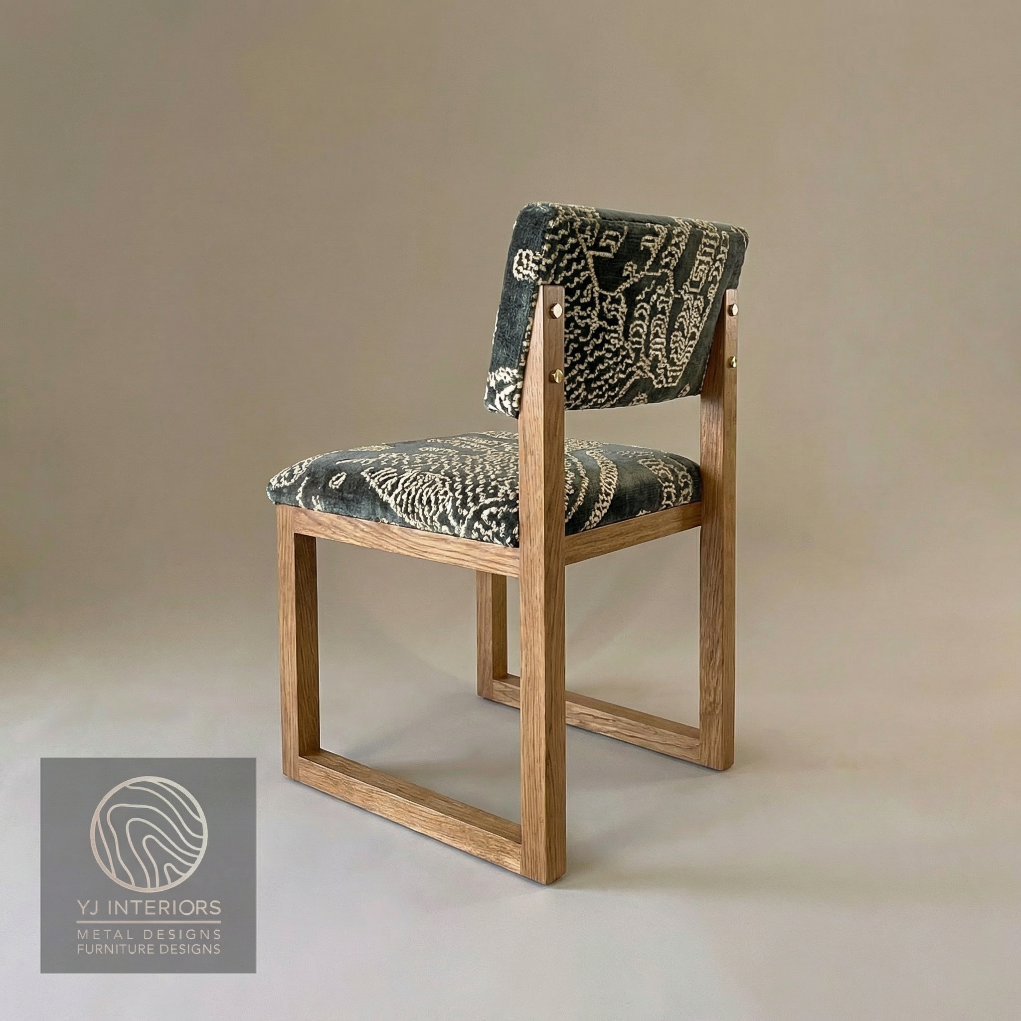 Chair with Dedar jacquard velvet patterned cushion on a beige background, featuring YJ Interiors logo.