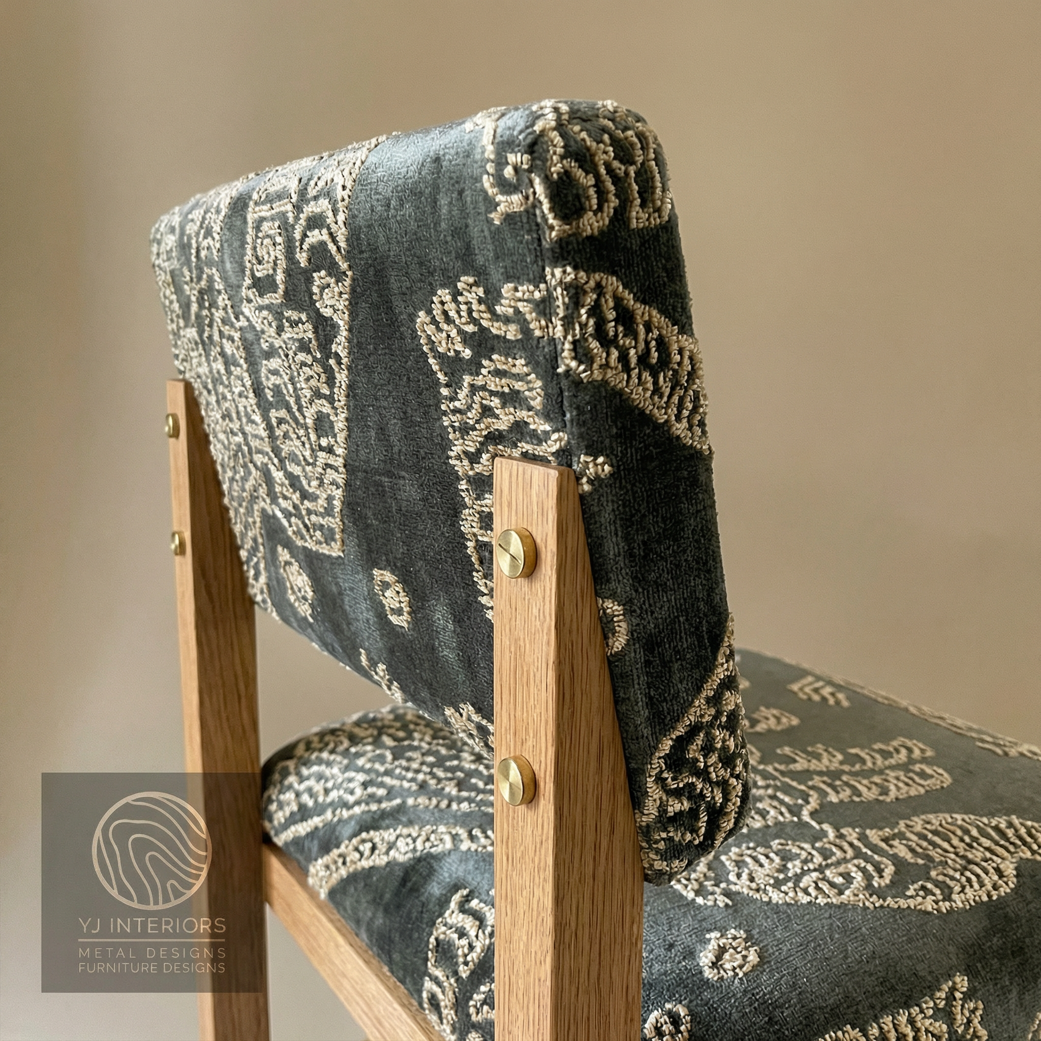 Chair with Dedar jacquard velvet patterned cushion on a beige background, featuring YJ Interiors logo.