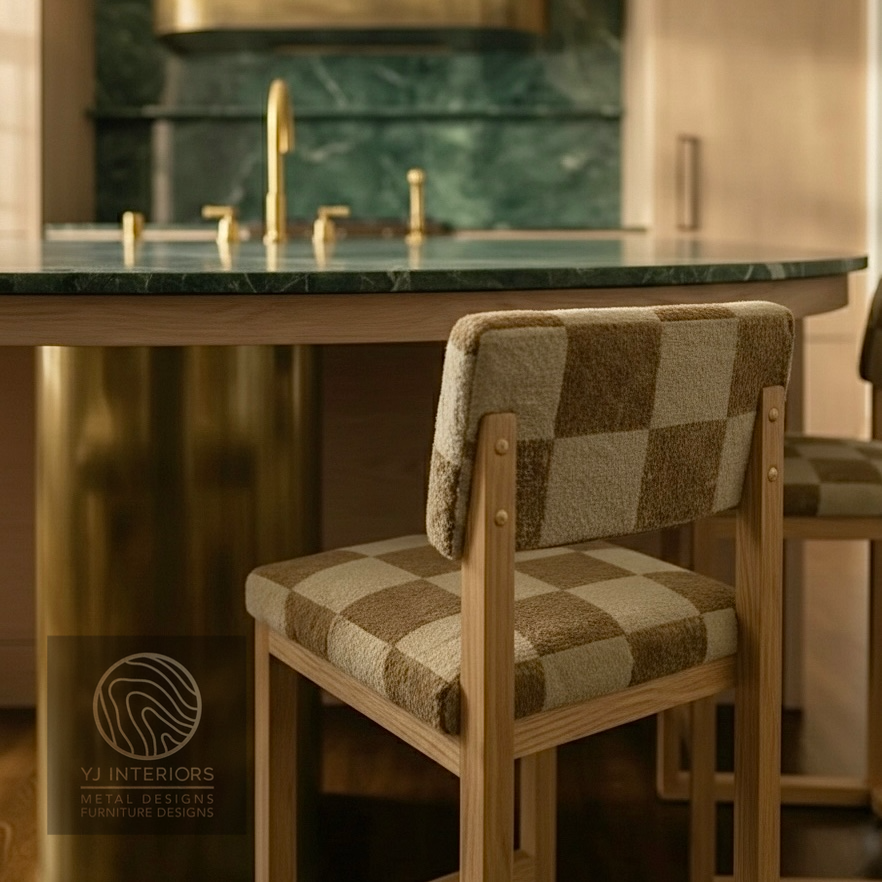 Checkered cushioned chair in a kitchen setting with a green marble countertop and gold fixtures.