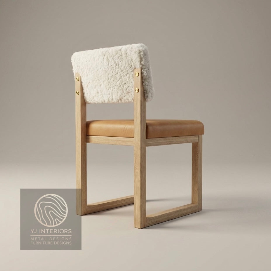 Chair with sheepskin backrest and wooden frame on a neutral background, featuring YJ Interiors logo.